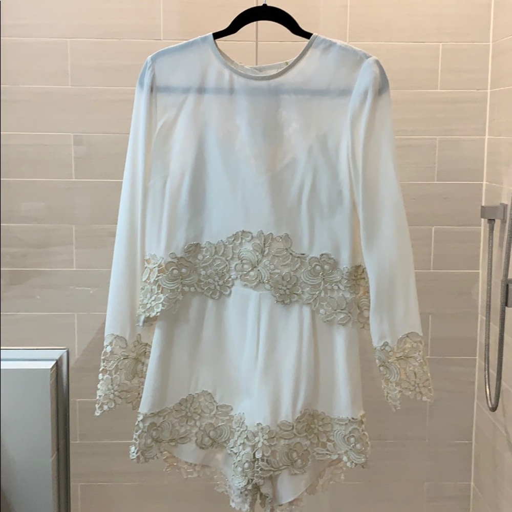 White with gold lace romper by Saylor